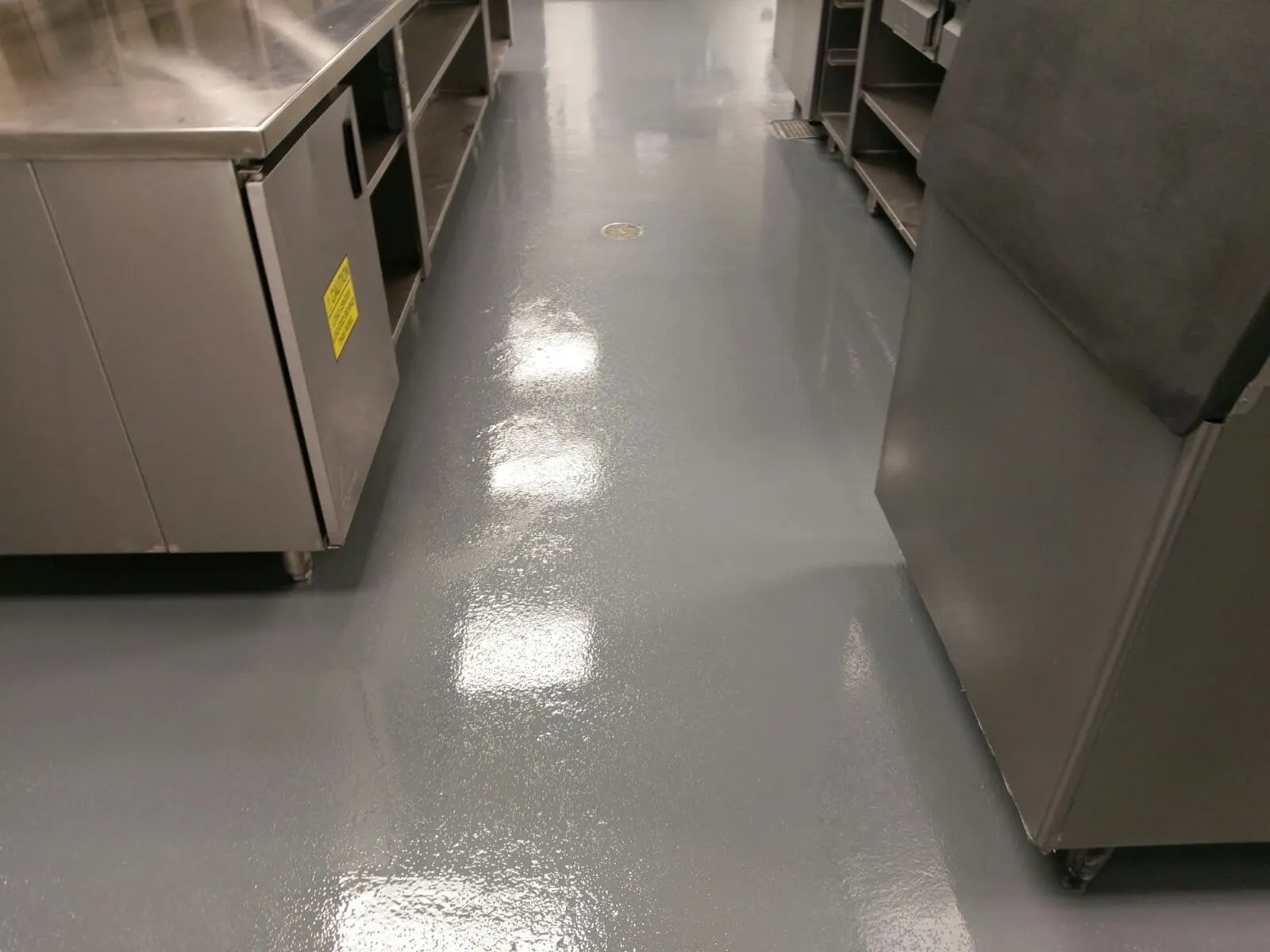 Resin floor under a stainless steel commercial kitchen prep line