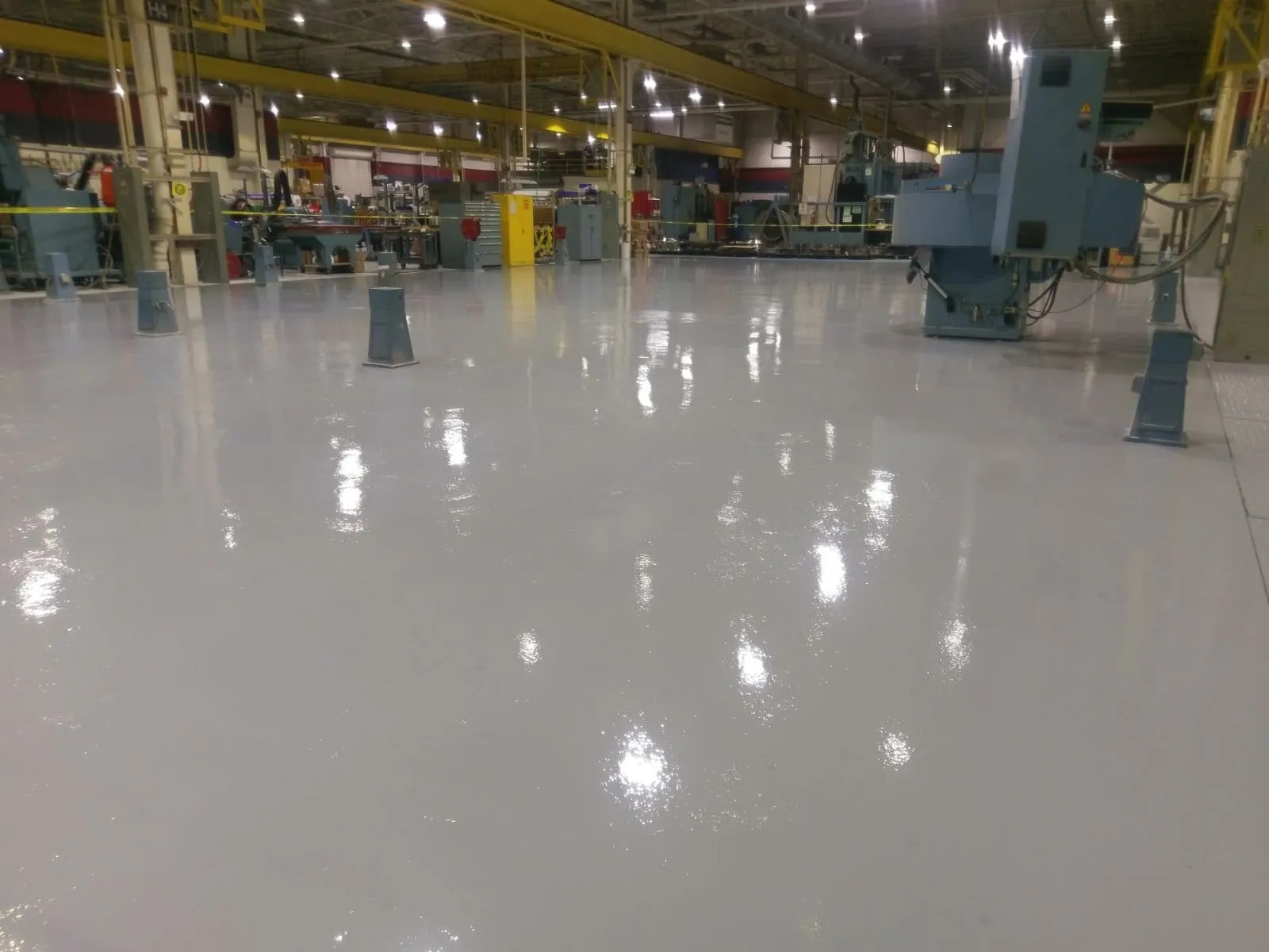 Solid grey epoxy floor running through an industrial plant