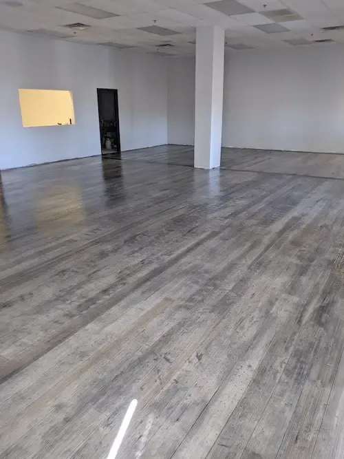 Grey-washed wood-look overlay through an empty commercial space